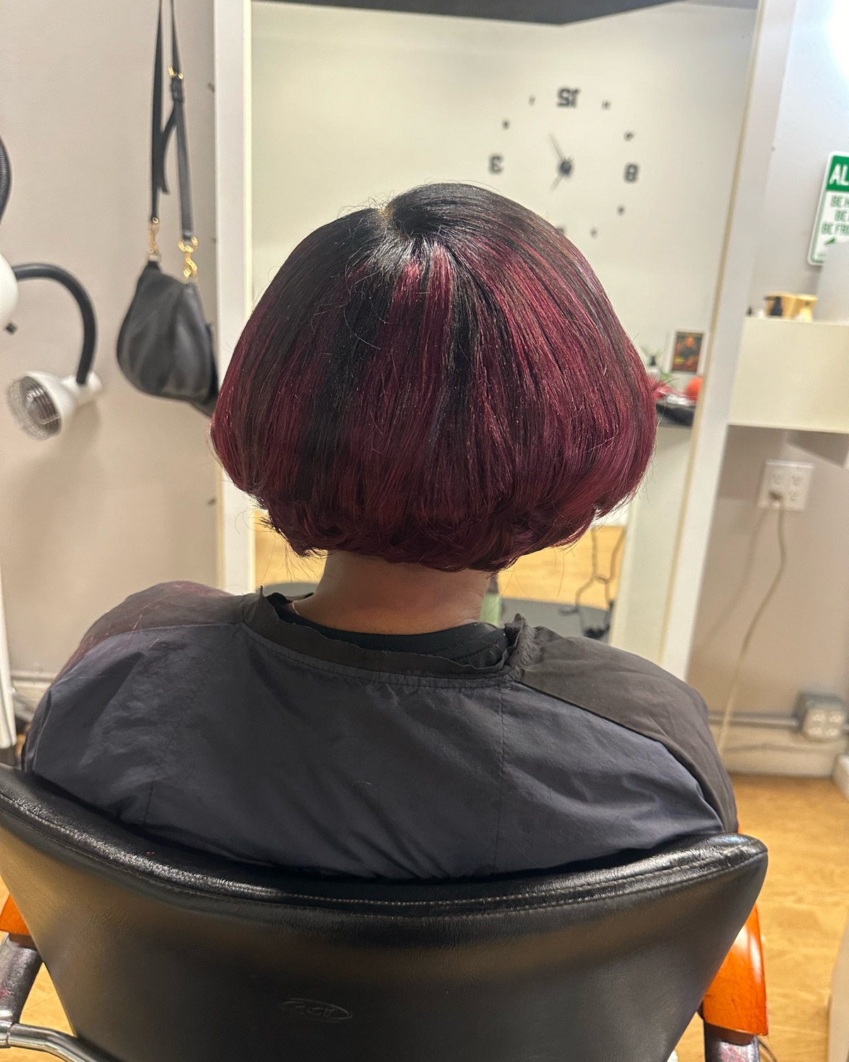 Burgundy layered bob, back view styled at Royal Touch Studio
