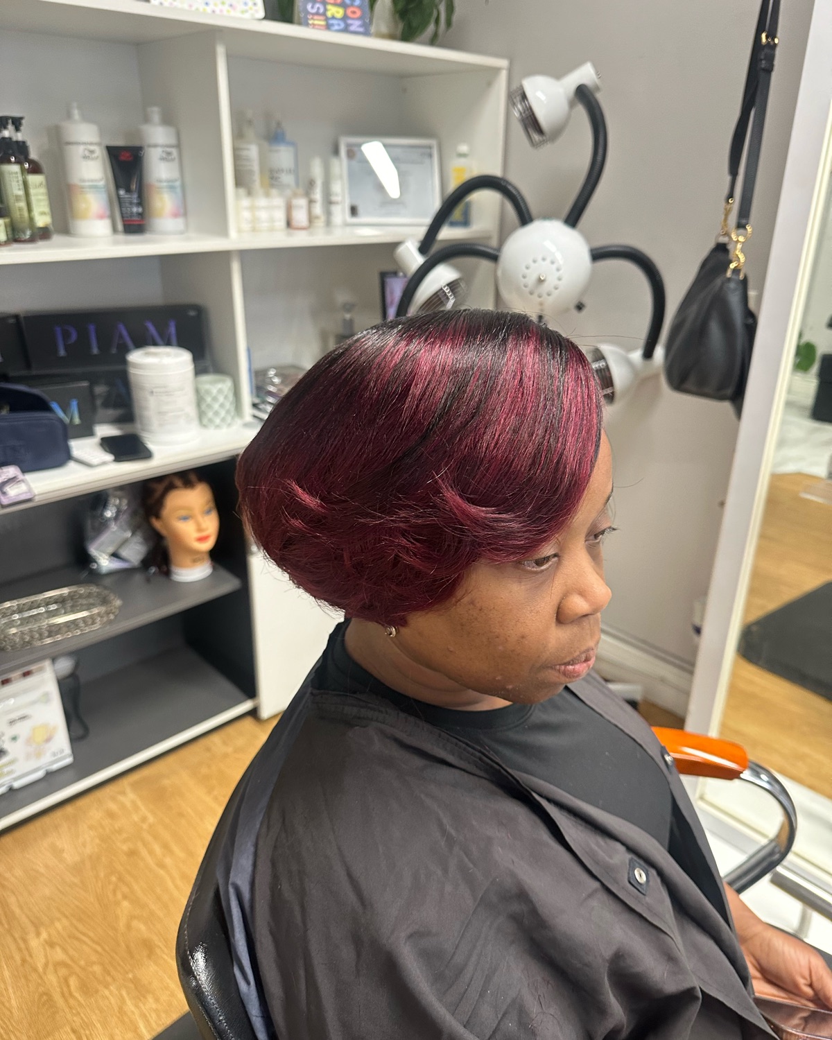Burgundy layered bob, side view styled at Royal Touch Studio
