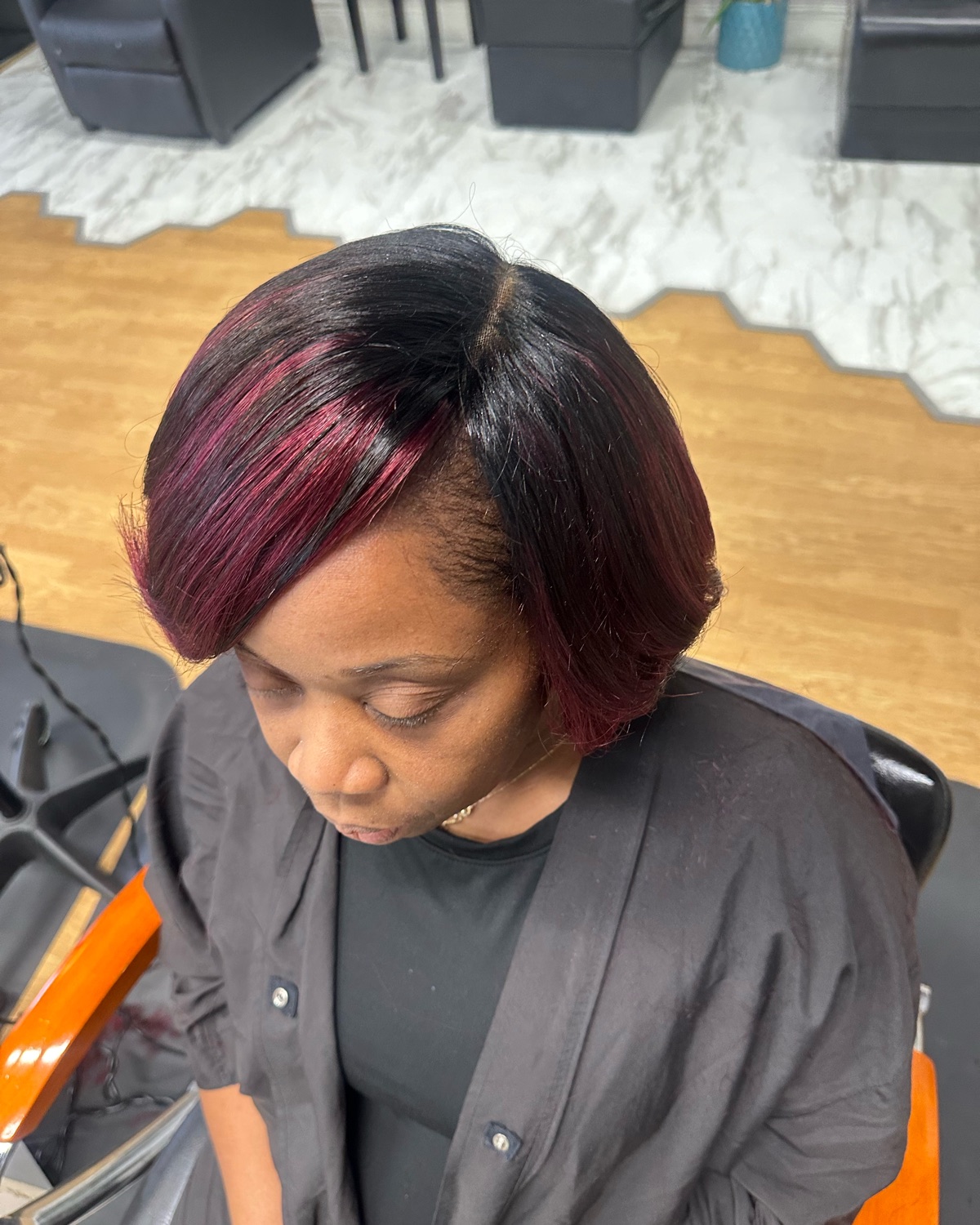 Burgundy layered bob, top view styled at Royal Touch Studio