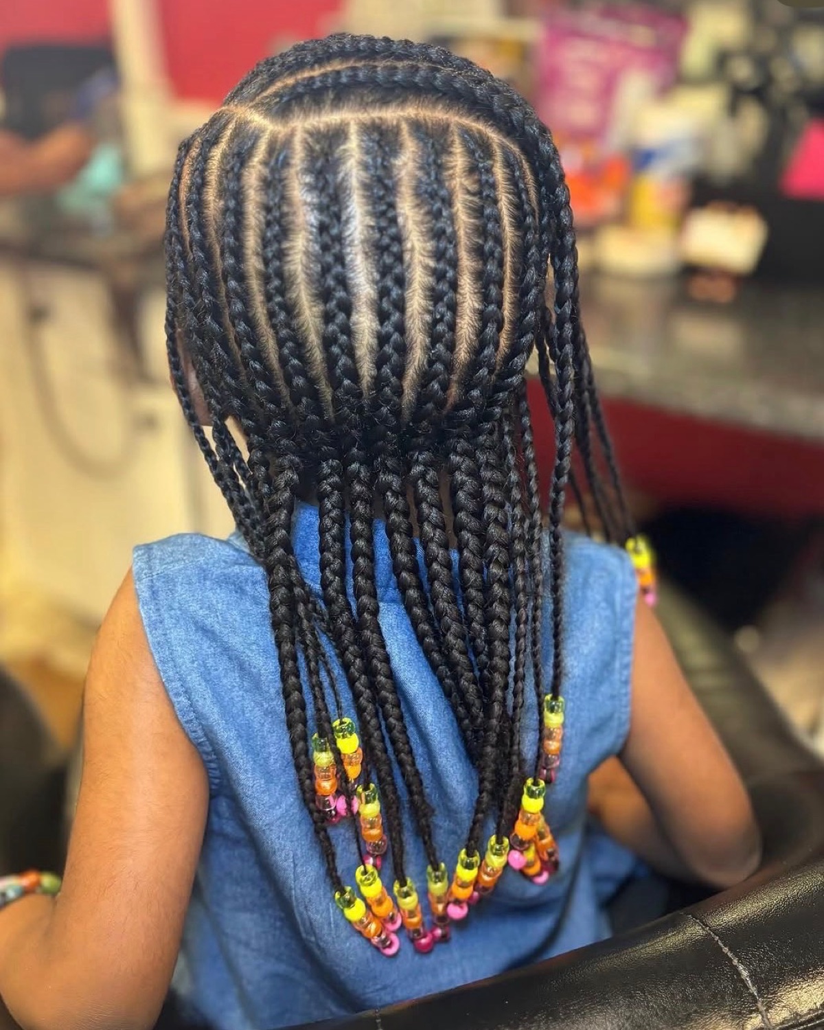 Cornrows with colorful beads styled at Royal Touch Studio