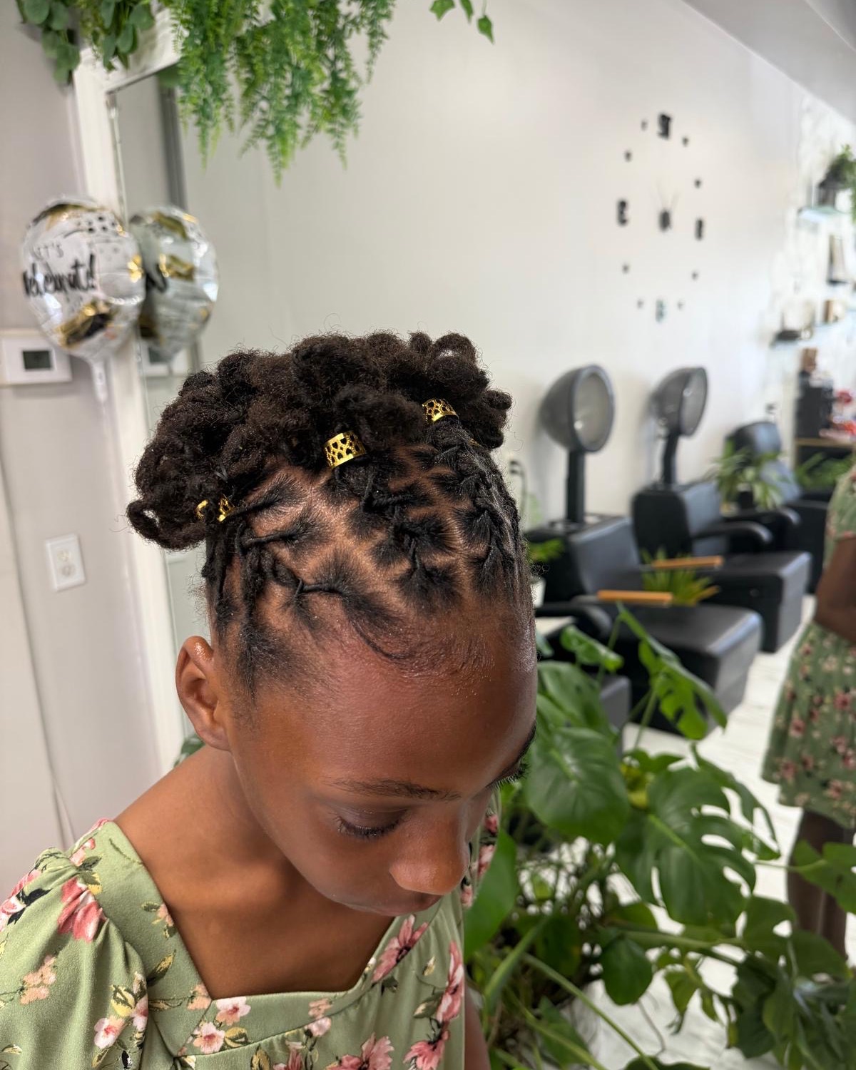 Loc updo with gold cuffs styled at Royal Touch Studio